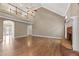 Open living room with hardwood floors and fireplace, featuring an overhanging walkway at 711 Wilhaven Ct, Loganville, GA 30052