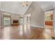 Open-concept living room with fireplace, hardwood floors, and neutral color palette at 711 Wilhaven Ct, Loganville, GA 30052