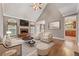Staged living room with fireplace, hardwood floors, and neutral color palette at 711 Wilhaven Ct, Loganville, GA 30052