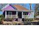 Charming purple home with a cozy front porch and white railings offers curb appeal at 885 White Sw St, Atlanta, GA 30310