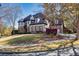 Beautiful curb appeal with a blend of stone and siding, set on a manicured lawn with mature trees at 3491 Falls Branch Ct, Buford, GA 30519