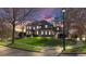 Stately home with manicured lawn, beautiful architecture and a welcoming curb appeal during sunset at 3491 Falls Branch Ct, Buford, GA 30519