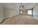 Large bedroom with neutral carpet, ceiling fan, vaulted ceiling and plenty of natural light at 4590 Carver Ct, Cumming, GA 30040