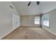 Bedroom features a ceiling fan, double-door closet and a window at 4590 Carver Ct, Cumming, GA 30040