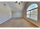 Bedroom features a ceiling fan, vaulted ceilings and a window at 4590 Carver Ct, Cumming, GA 30040