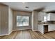 Eat-in kitchen with stainless steel dishwasher, white cabinets, granite countertops, and a large window at 4590 Carver Ct, Cumming, GA 30040