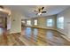 Spacious living room featuring wood-look flooring, many windows, and a ceiling fan at 4590 Carver Ct, Cumming, GA 30040