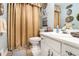 Vintage bathroom with patterned shower curtain and decorative wall art at 5395 Steeple Chase, Douglasville, GA 30135