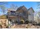 Exterior view of a multi-level deck and patio area, complemented by a well-maintained yard and landscaping at 5395 Steeple Chase, Douglasville, GA 30135