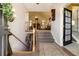 Welcoming foyer with wooden staircase, railing, and a view into the living room, creating an inviting entrance at 5395 Steeple Chase, Douglasville, GA 30135