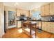 Well-lit kitchen showcasing stainless steel appliances, center island, and hardwood floors at 5395 Steeple Chase, Douglasville, GA 30135