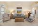 Cozy living room with neutral tones, comfortable seating, with artwork adorning the walls, and natural light at 5395 Steeple Chase, Douglasville, GA 30135