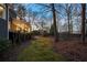 Lush backyard featuring tiered landscaping, bordered by a black metal fence at 740 Frank Kirk Nw Rd, Kennesaw, GA 30152