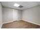 Well-lit basement area with wood flooring, neutral walls, and a white door offers a clean, adaptable space for customization at 740 Frank Kirk Nw Rd, Kennesaw, GA 30152