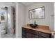 Bathroom featuring a modern vessel sink on a dark vanity, complemented by a rectangular mirror and tiled floors at 740 Frank Kirk Nw Rd, Kennesaw, GA 30152