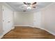 Bedroom featuring hardwood floors, a ceiling fan and trim at 740 Frank Kirk Nw Rd, Kennesaw, GA 30152