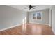 Sunlit bedroom features wood floors, ceiling fan and view of outside at 740 Frank Kirk Nw Rd, Kennesaw, GA 30152