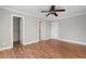 Well-lit bedroom features wood floors, ceiling fan, closet and multiple doors at 740 Frank Kirk Nw Rd, Kennesaw, GA 30152