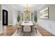 Formal dining room featuring modern chandelier, large windows, and stylish decor at 740 Frank Kirk Nw Rd, Kennesaw, GA 30152