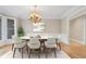 Formal dining room featuring modern chandelier, large windows, and stylish decor at 740 Frank Kirk Nw Rd, Kennesaw, GA 30152