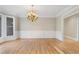 Light-filled dining room featuring hardwood floors and elegant chandelier at 740 Frank Kirk Nw Rd, Kennesaw, GA 30152