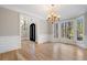 Light-filled dining room featuring hardwood floors and elegant chandelier at 740 Frank Kirk Nw Rd, Kennesaw, GA 30152