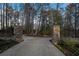 Stone gate with an address greets you as you enter the long driveway through the wooded front yard at 740 Frank Kirk Nw Rd, Kennesaw, GA 30152