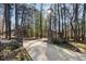 Stone pillars and wrought iron gate marking the entrance to the tree-lined property at 740 Frank Kirk Nw Rd, Kennesaw, GA 30152