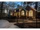 Rear view of the home exterior featuring a fenced-in yard and beautiful trees at 740 Frank Kirk Nw Rd, Kennesaw, GA 30152