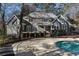 Gray home features a well-manicured lawn, a pool, and double doors leading to a deck at 740 Frank Kirk Nw Rd, Kennesaw, GA 30152