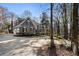 Stately gray home with a circular driveway surrounded by lush landscaping and mature trees at 740 Frank Kirk Nw Rd, Kennesaw, GA 30152