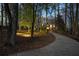 Exterior view of the home, showcasing the long driveway leading to the property, surrounded by trees and landscaping at 740 Frank Kirk Nw Rd, Kennesaw, GA 30152