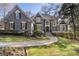 Elegant gray home showcasing a manicured front yard and stunning architectural details at 740 Frank Kirk Nw Rd, Kennesaw, GA 30152