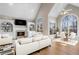 Bright living room with fireplace, vaulted ceiling, large arched windows, and elegant decor at 740 Frank Kirk Nw Rd, Kennesaw, GA 30152