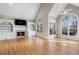 Spacious living room with fireplace, built-in shelving, high ceilings, and natural light from large windows at 740 Frank Kirk Nw Rd, Kennesaw, GA 30152