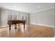 Spacious living room with hardwood floors and double doors to a view of mature trees at 740 Frank Kirk Nw Rd, Kennesaw, GA 30152