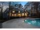 Inviting backyard pool with a concrete patio area, and view of the house with trees surrounding the yard at 740 Frank Kirk Nw Rd, Kennesaw, GA 30152