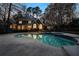 Beautiful backyard pool, with the light from the house reflecting in the water and trees surrounding the property at 740 Frank Kirk Nw Rd, Kennesaw, GA 30152