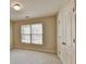 Cozy bedroom features neutral walls, soft carpeting, and a closet, with natural light from the windows at 106 Little Barley Ln, Grayson, GA 30017