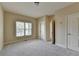 Bedroom features a window, neutral carpet and paint, with doorways to other rooms at 106 Little Barley Ln, Grayson, GA 30017