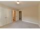 A neutral-toned bedroom is shown with double closets and connecting bathroom with a tiled floor at 106 Little Barley Ln, Grayson, GA 30017