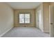 Bedroom with neutral carpet and paint, a window, base trim molding, and white door at 106 Little Barley Ln, Grayson, GA 30017