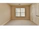 Bedroom with neutral walls, soft carpet, and natural light from a window creates a serene and inviting atmosphere at 106 Little Barley Ln, Grayson, GA 30017