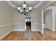 Dining area with hardwood floors and a modern chandelier at 106 Little Barley Ln, Grayson, GA 30017