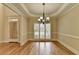 Bright dining room with hardwood floors, white trim, and a window overlooking the front yard at 106 Little Barley Ln, Grayson, GA 30017