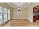 Traditional dining room featuring hardwood floors, modern chandelier, and large window for ample natural light at 106 Little Barley Ln, Grayson, GA 30017