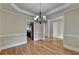 Spacious dining room featuring hardwood floors and an elegant chandelier at 106 Little Barley Ln, Grayson, GA 30017