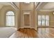 Elegant foyer with hardwood floors, high ceilings, arched windows, and neutral paint palette at 106 Little Barley Ln, Grayson, GA 30017