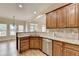 Open concept kitchen with granite countertops, stainless steel dishwasher, and hardwood floors at 106 Little Barley Ln, Grayson, GA 30017