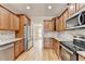 Well-designed kitchen with stainless steel appliances and stone backsplash at 106 Little Barley Ln, Grayson, GA 30017